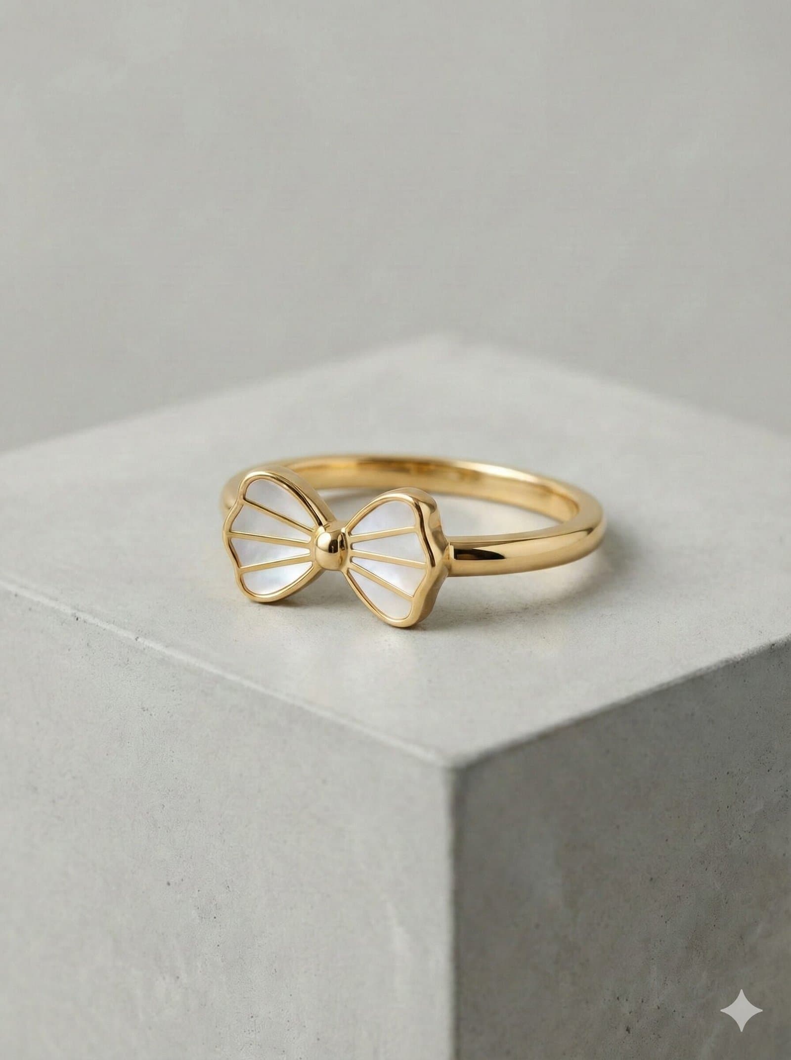 Elegant Gold-Tone Bow Ring with White Pearlescent Inlay and Radial Detailing — image 1