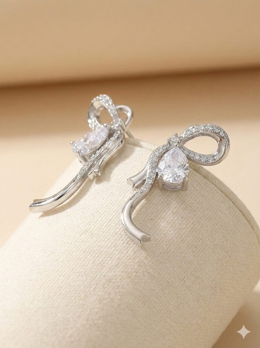 Silver-Toned Pave Ribbon Bow Stud Earrings with Pear-Cut Stone Accent