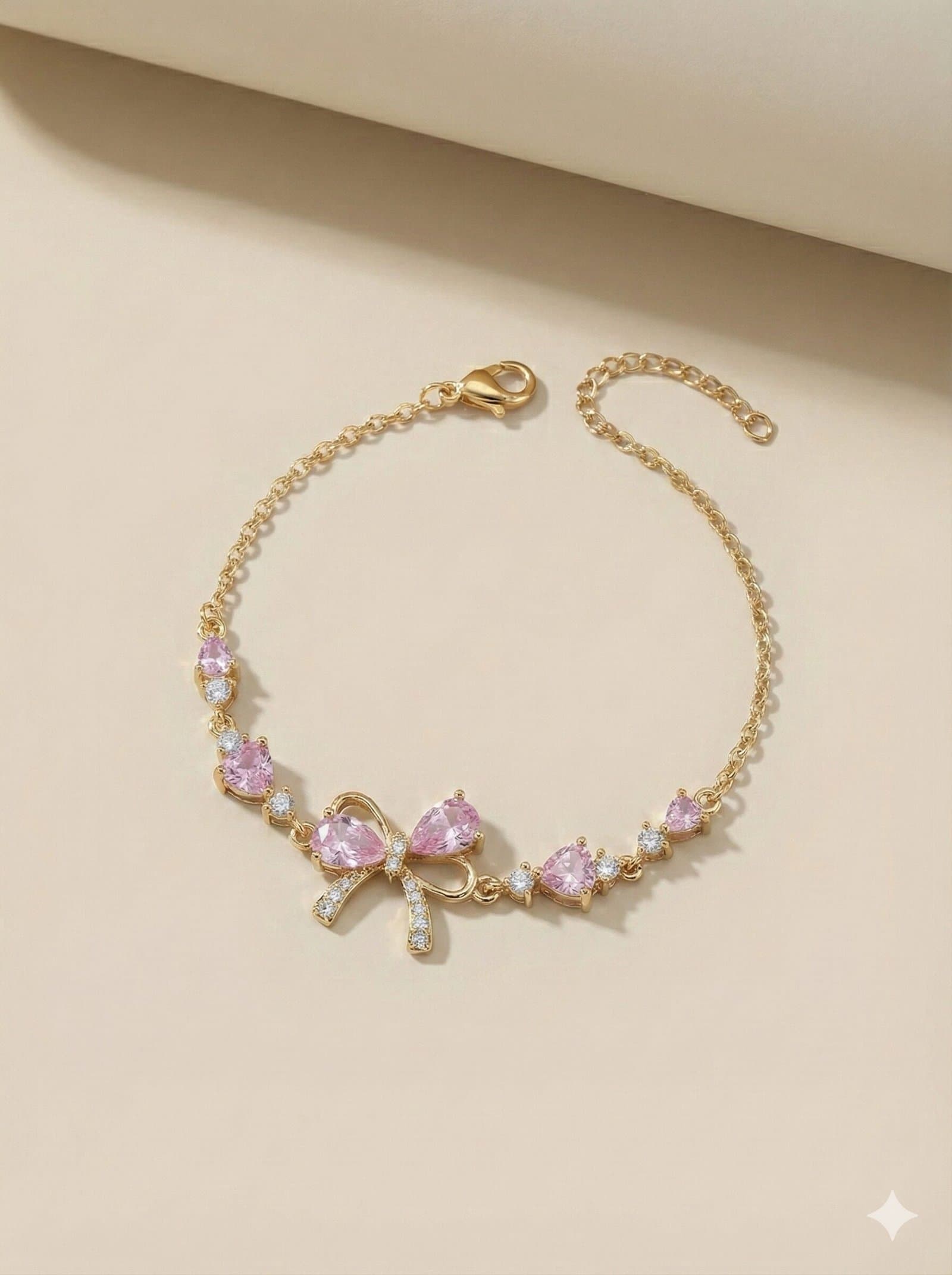 Gold-Tone Adjustable Chain Bracelet with Pink Teardrop Stones and Pave-Style Bow Charm — image 1
